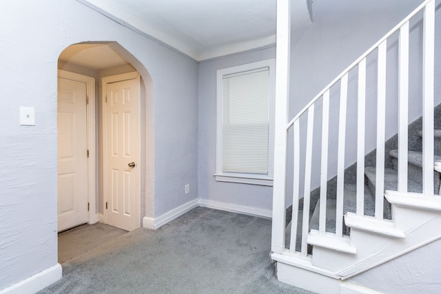 view of carpeted foyer entrance