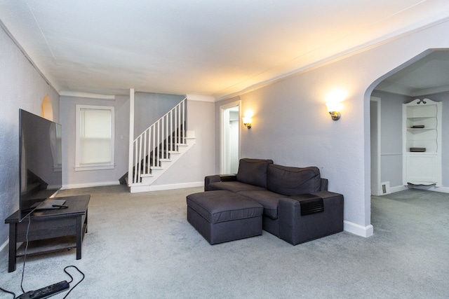 carpeted living room featuring ornamental molding