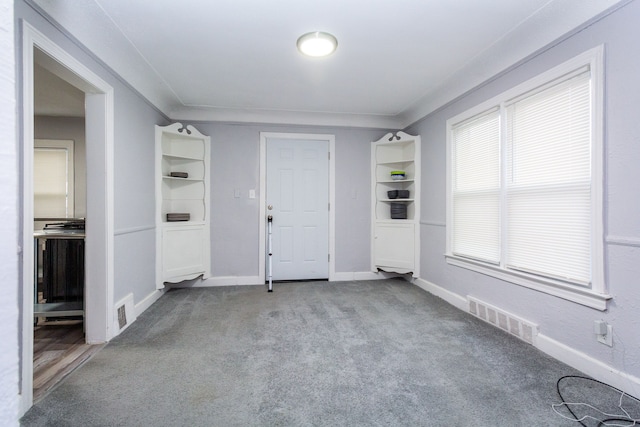 carpeted spare room featuring ornamental molding