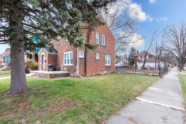 view of side of home featuring a patio and a lawn