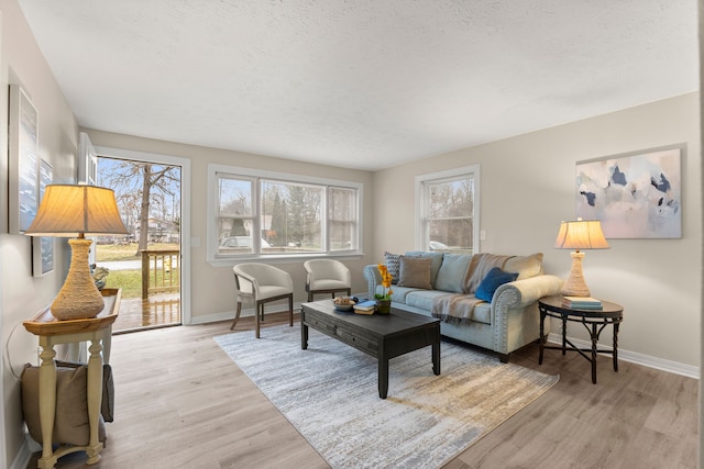 living room featuring a textured ceiling and light wood-type flooring