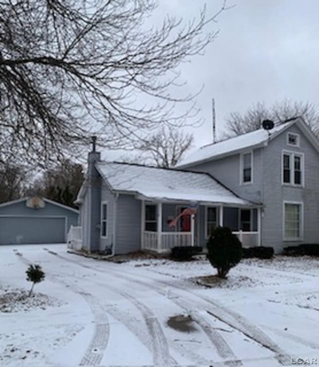 front facade featuring an outdoor structure and a garage