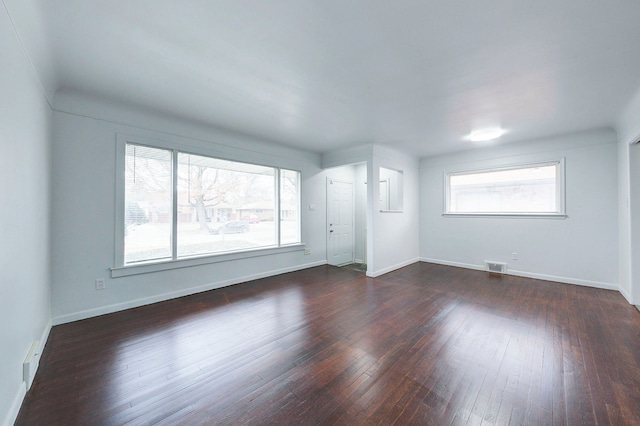 spare room featuring dark wood-type flooring