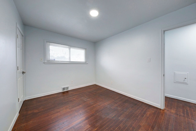 spare room featuring dark hardwood / wood-style floors