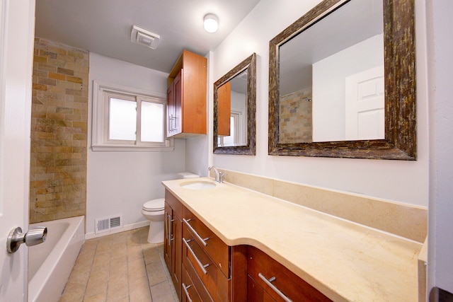 full bathroom featuring tiled shower / bath, vanity, and toilet