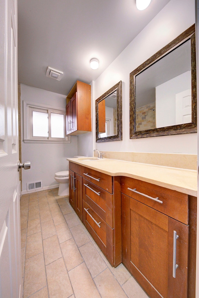 bathroom with tile patterned floors, vanity, and toilet