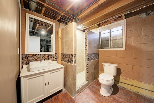 bathroom featuring vanity, toilet, wood-type flooring, and a shower