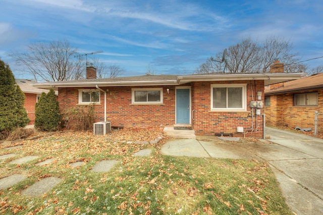 ranch-style house with cooling unit