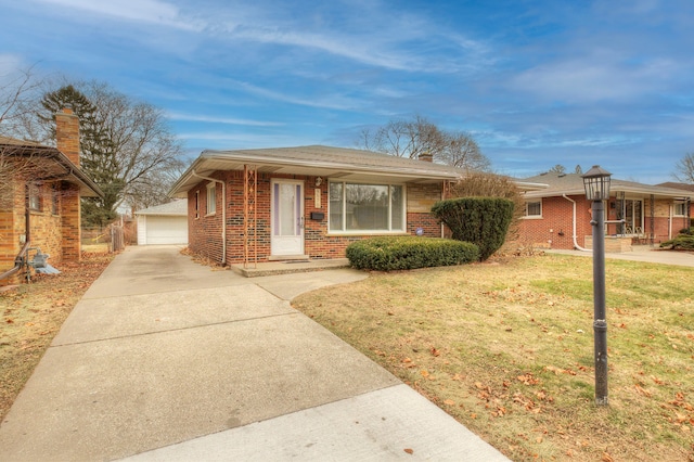 view of front of property with a garage, an outdoor structure, and a front yard