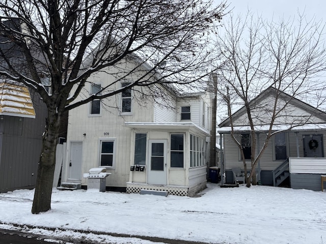 view of snow covered rear of property