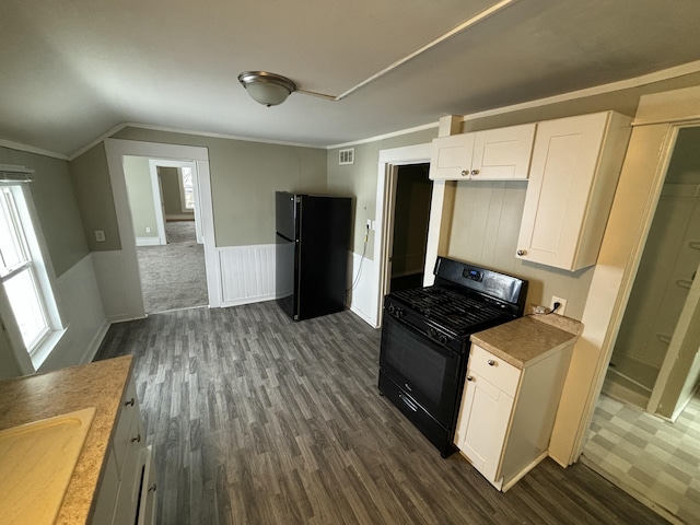 kitchen with white cabinetry, sink, dark hardwood / wood-style floors, vaulted ceiling, and black appliances