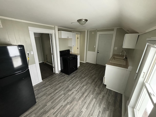 kitchen featuring white cabinetry, sink, dark hardwood / wood-style floors, lofted ceiling, and black appliances