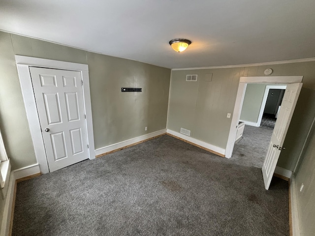 carpeted empty room with crown molding