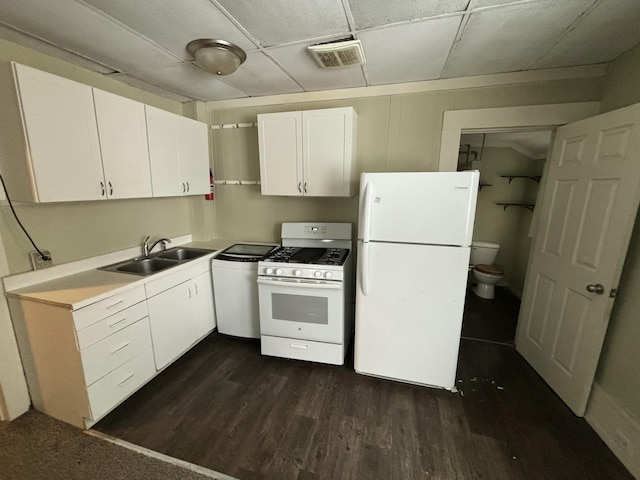 kitchen featuring white appliances, dark hardwood / wood-style floors, white cabinetry, and sink