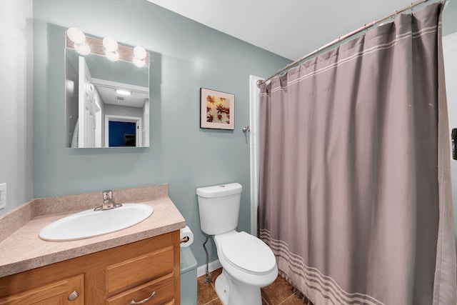 bathroom featuring tile patterned floors, walk in shower, vanity, and toilet