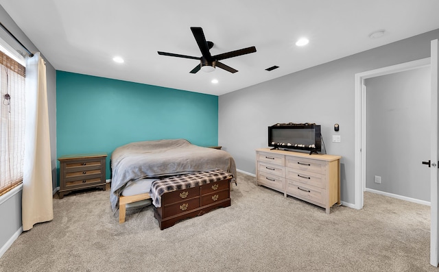 bedroom featuring light carpet and ceiling fan