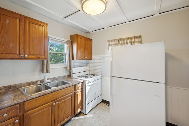 kitchen with decorative backsplash, sink, and white appliances