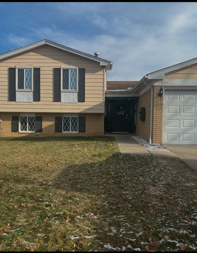 view of front of house with a garage and a front lawn