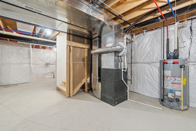 basement featuring heating unit and water heater