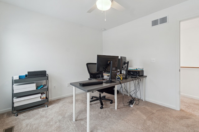 home office featuring light carpet and ceiling fan