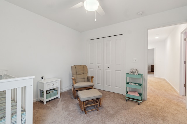 carpeted bedroom with ceiling fan and a closet