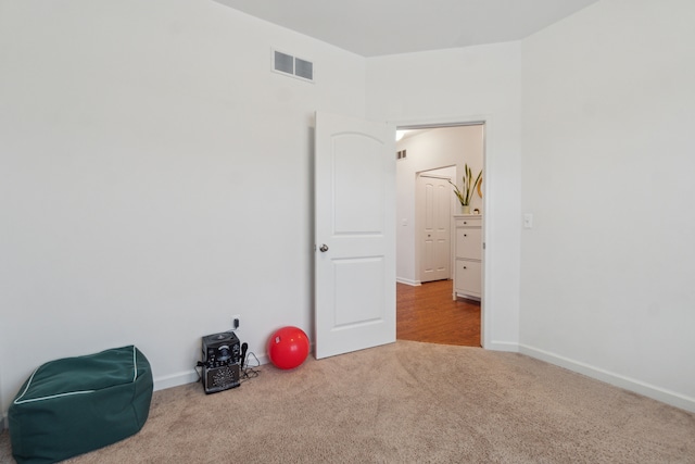 spare room featuring light colored carpet