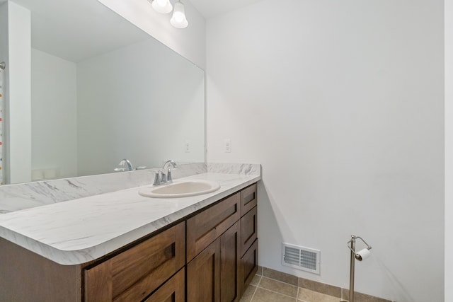 bathroom with tile patterned flooring and vanity