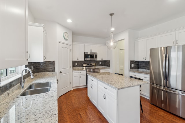 kitchen featuring a center island, sink, white cabinets, and stainless steel appliances