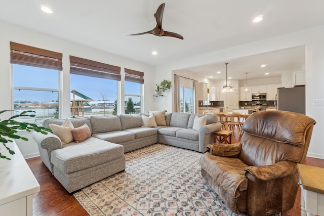 living room featuring hardwood / wood-style floors and ceiling fan