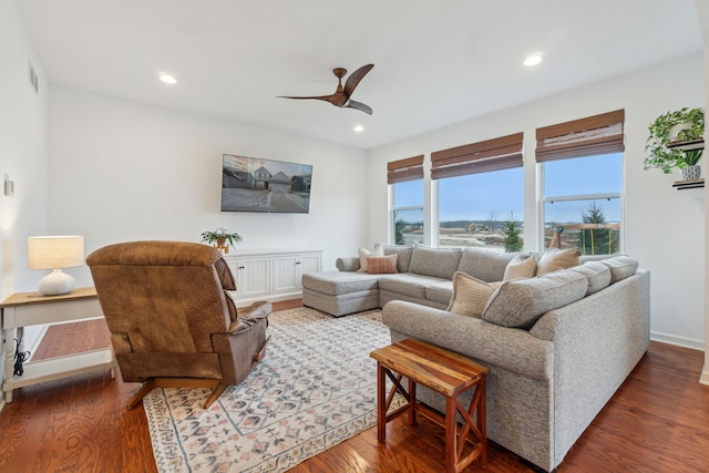 living room featuring ceiling fan and hardwood / wood-style flooring