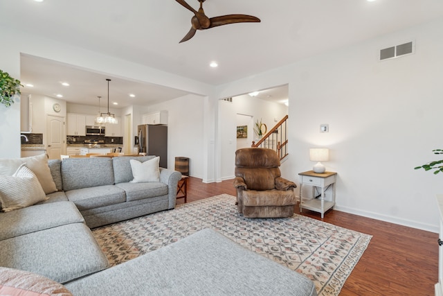 living room featuring ceiling fan and hardwood / wood-style flooring