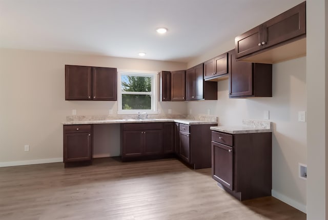 704 Eden St, Kingsley, MI 49649 - kitchen featuring dark brown cabinets, light wood-style flooring, light countertops, and recessed lighting