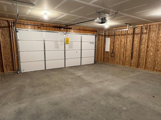 704 Eden St, Kingsley, MI 49649 - garage featuring a garage door opener