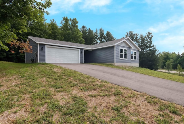 704 Eden St, Kingsley, MI 49649 - view of front of property with driveway, a garage, and a front yard
