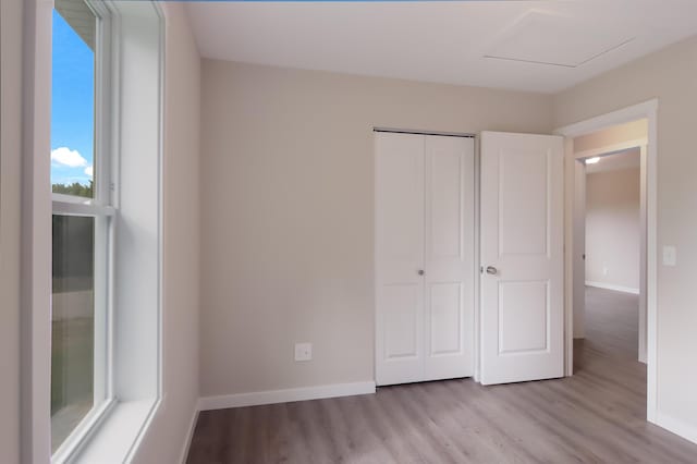 704 Eden St, Kingsley, MI 49649 - unfurnished bedroom featuring wood finished floors and a closet