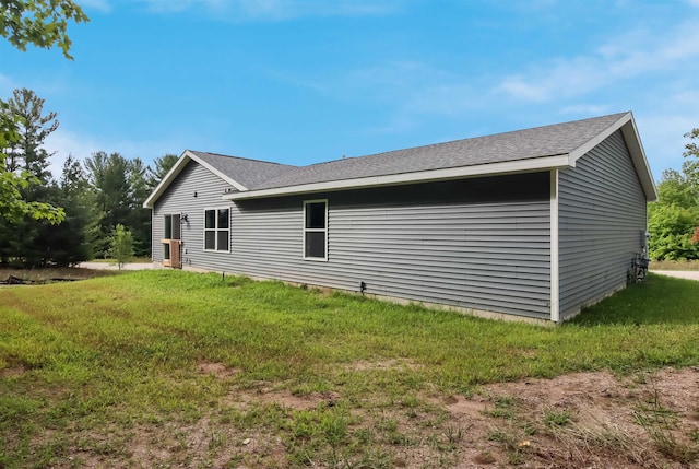 704 Eden St, Kingsley, MI 49649 - view of property exterior with a yard and roof with shingles