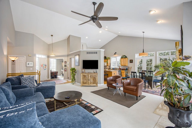 living room with ceiling fan, light carpet, and high vaulted ceiling