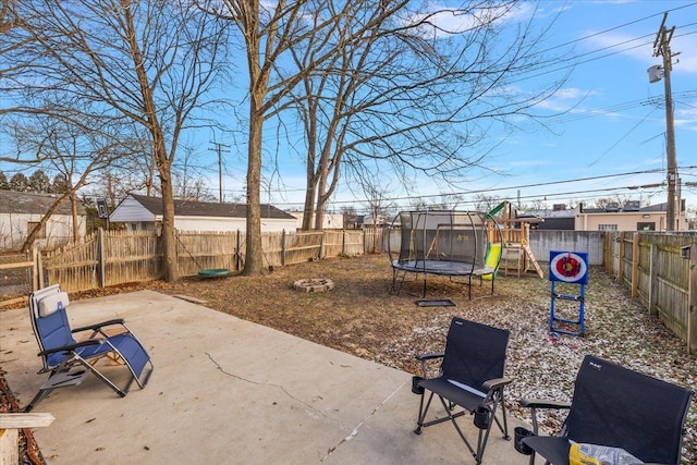 view of patio with a playground and a trampoline