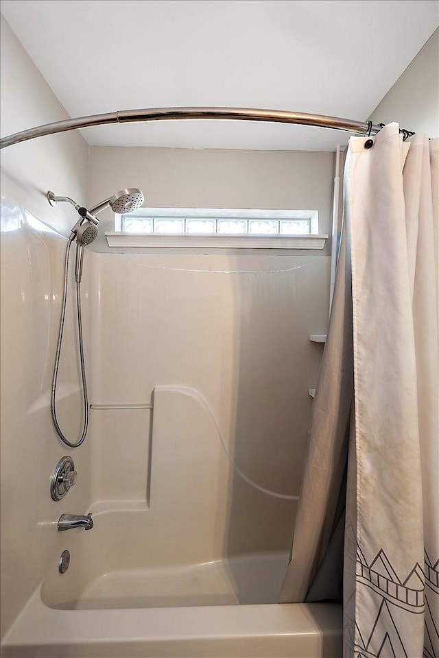 bathroom featuring plenty of natural light and shower / bath combination with curtain