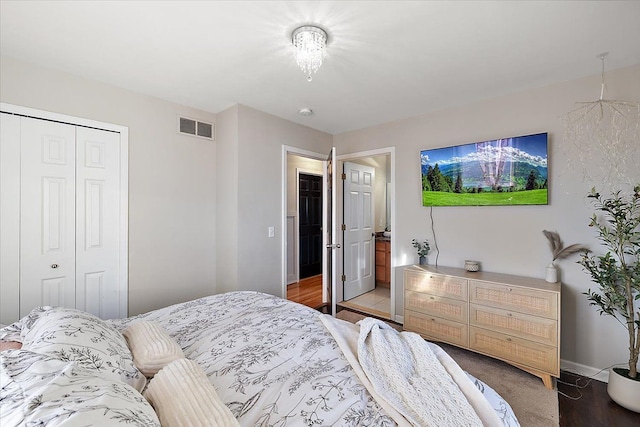 bedroom with wood-type flooring and a closet