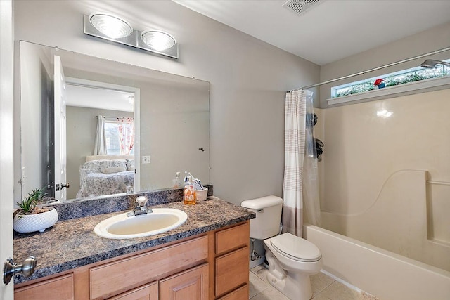 full bathroom with tile patterned flooring, vanity, toilet, and shower / bath combo with shower curtain