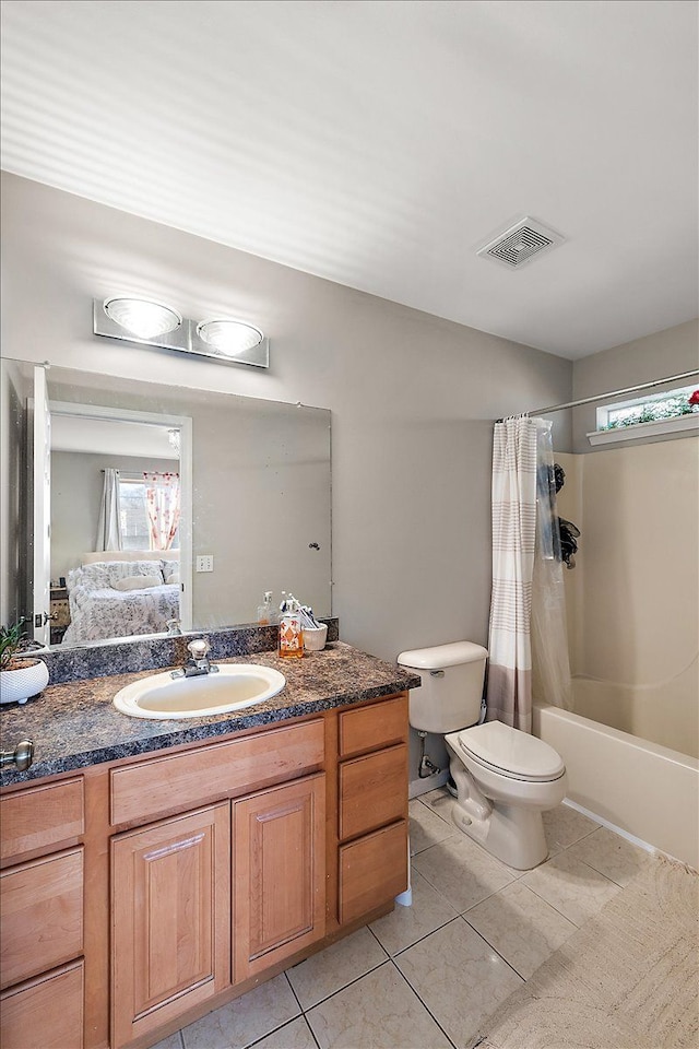 full bathroom featuring shower / bath combo, vanity, toilet, and a wealth of natural light