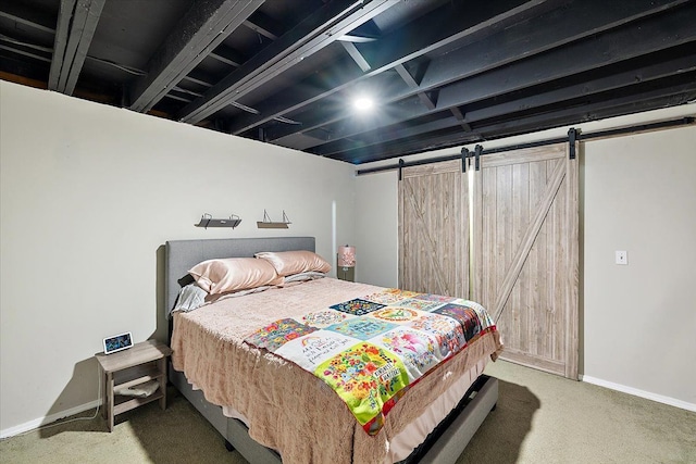 carpeted bedroom featuring a barn door