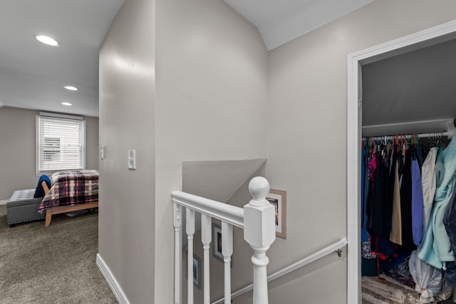 hall with carpet flooring and lofted ceiling