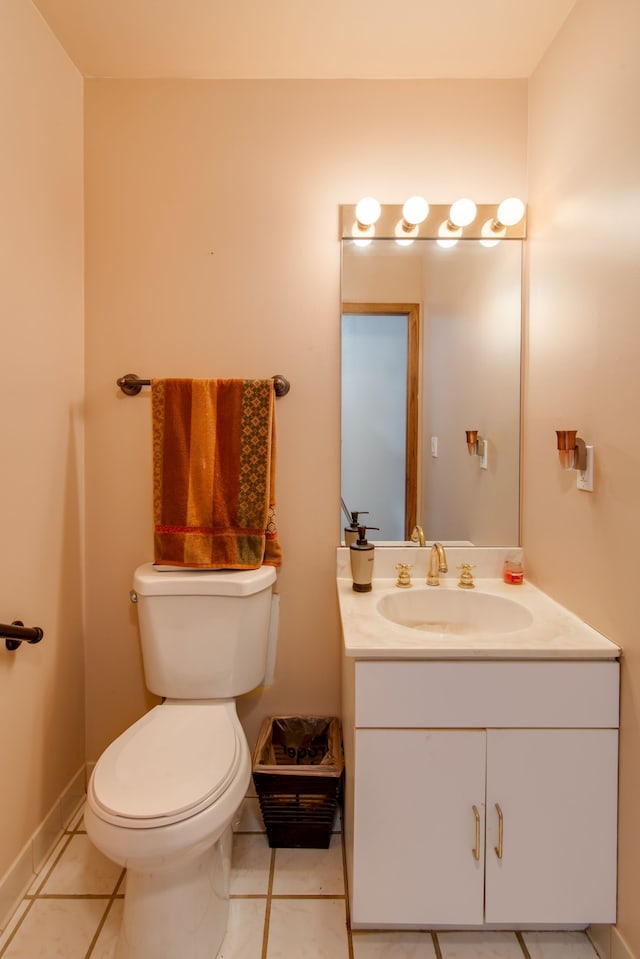 bathroom with toilet, tile patterned floors, and vanity