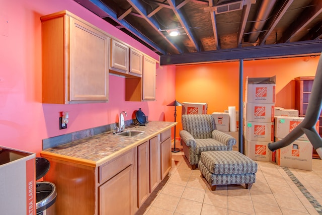 interior space with light tile patterned floors, light brown cabinetry, and sink