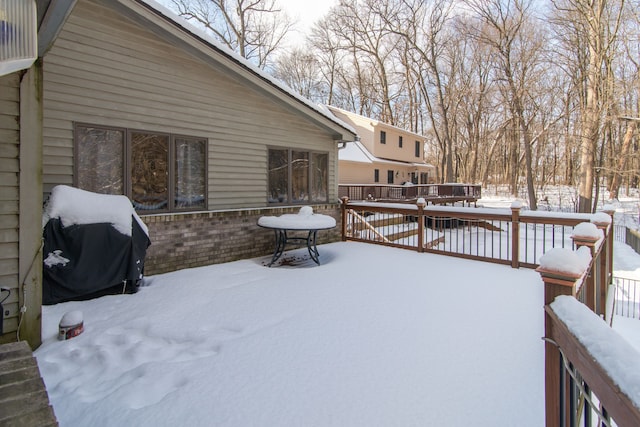 snow covered deck featuring grilling area