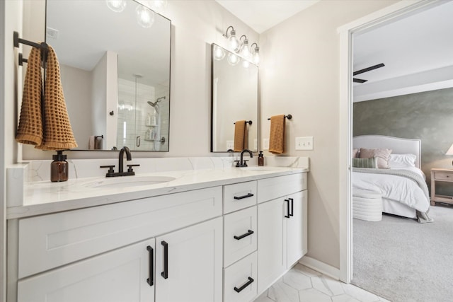 bathroom with vanity, a shower with door, and ceiling fan