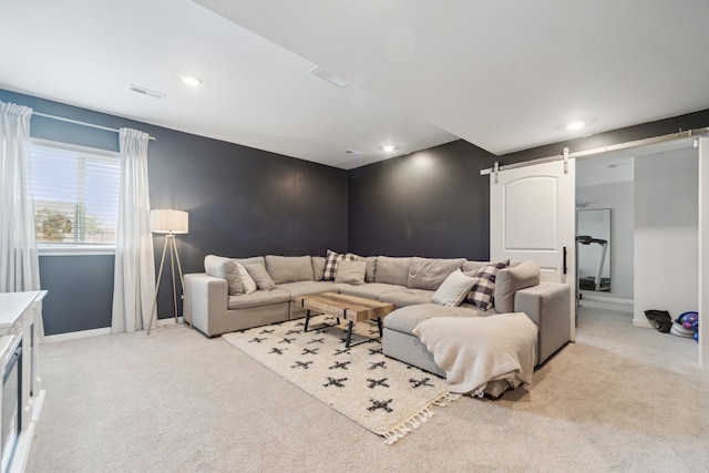 carpeted living room with a barn door