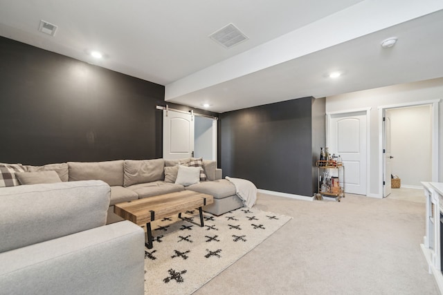 carpeted living room featuring a barn door